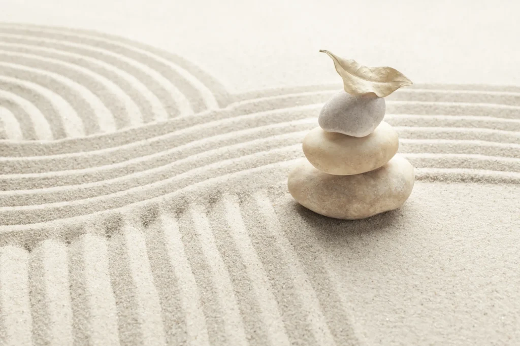 Stacked zen marble stones sand background mindfulness concept